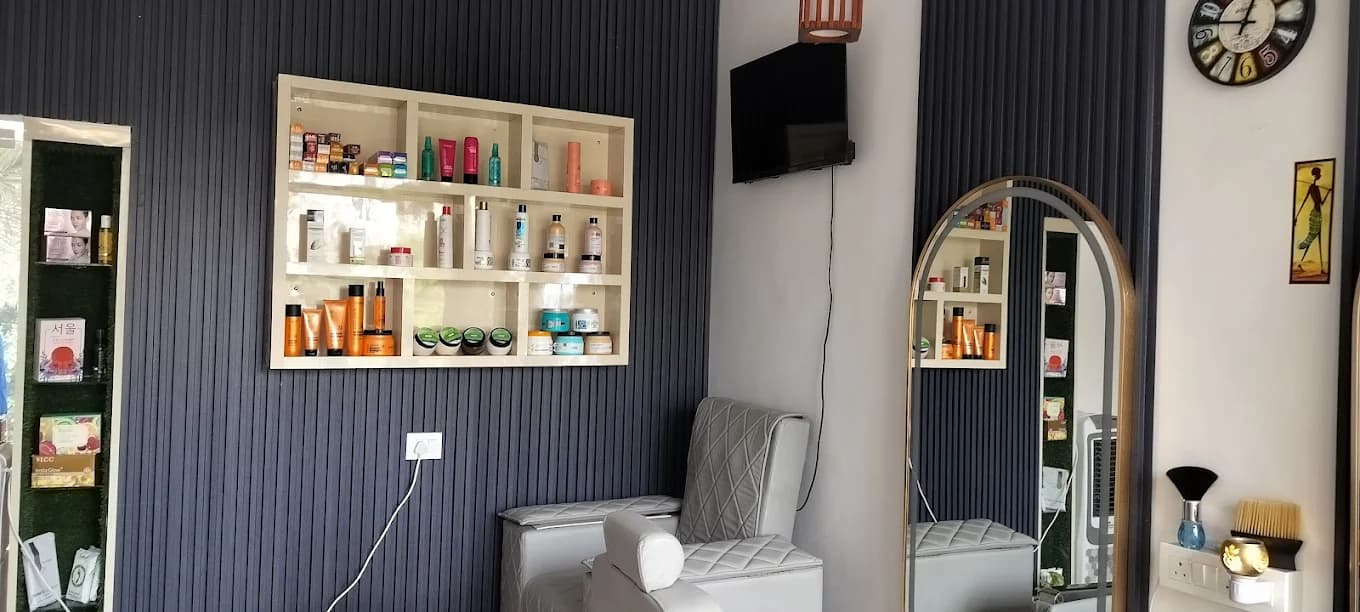 Styling chairs and a retail shelf of hair and skin care products inside Glow Studio